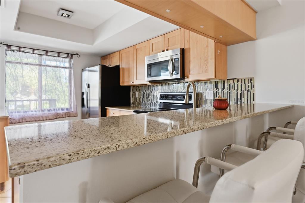 The breakfast bar is ideal for a quick meal with the dining area nearby for a sit-down dinner.