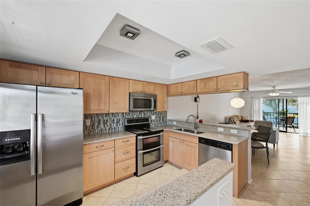 Stunning updated kitchen offers plenty of storage, newer appliances, warm cabinetry and sophisticated details.