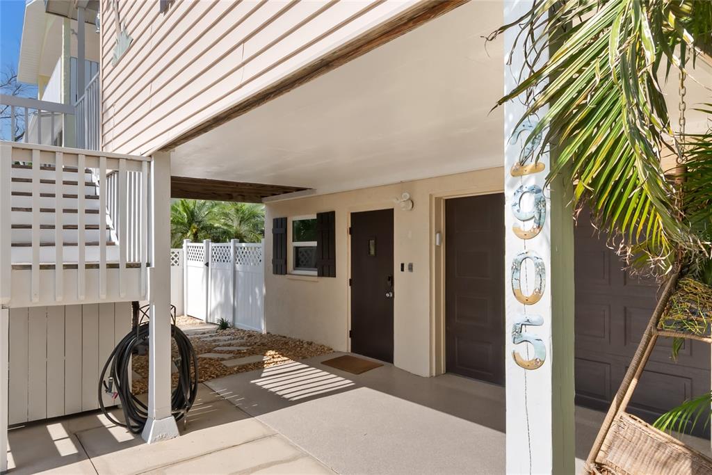 Outdoor shower under steps and alt. entry to home.