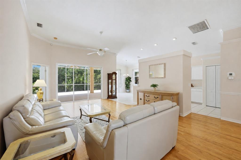 Open-concept living room with hardwood floors, large windows and abundant natural light