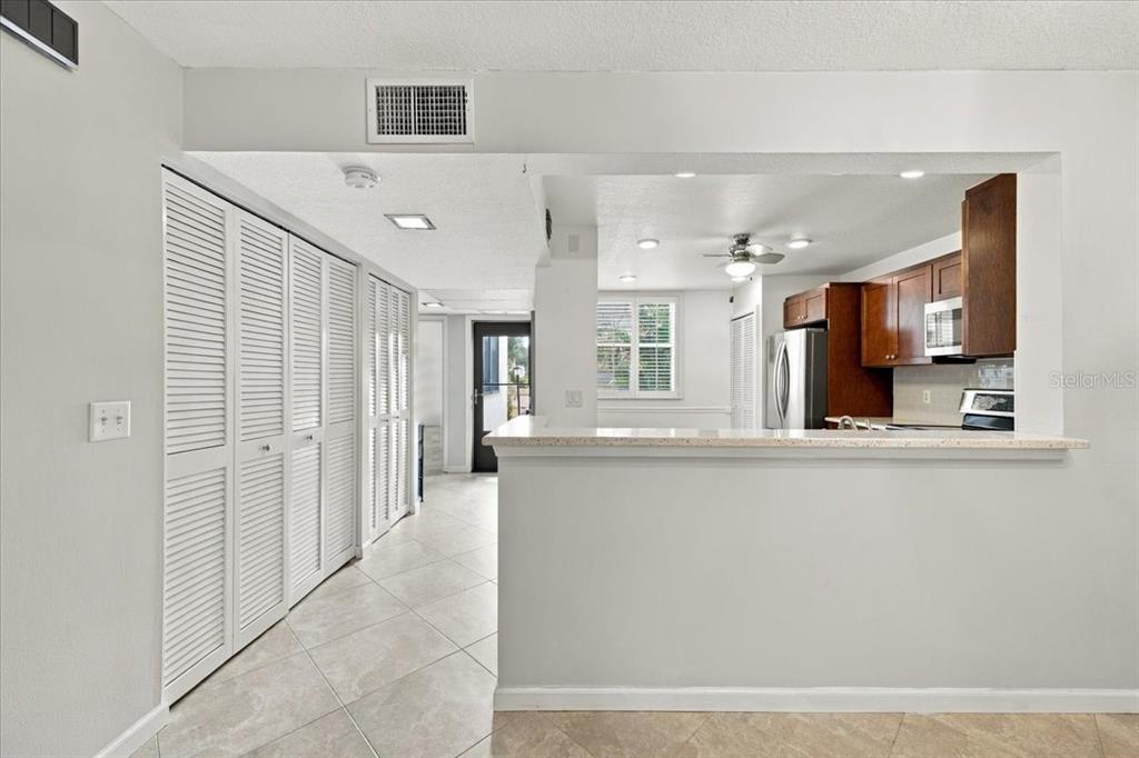 Hallway into unit with two closets