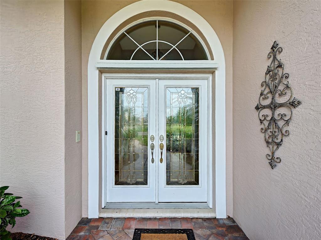 Semi-custom J & J built home makes such an impact with its paver path, lead double doors and gracious entryway.