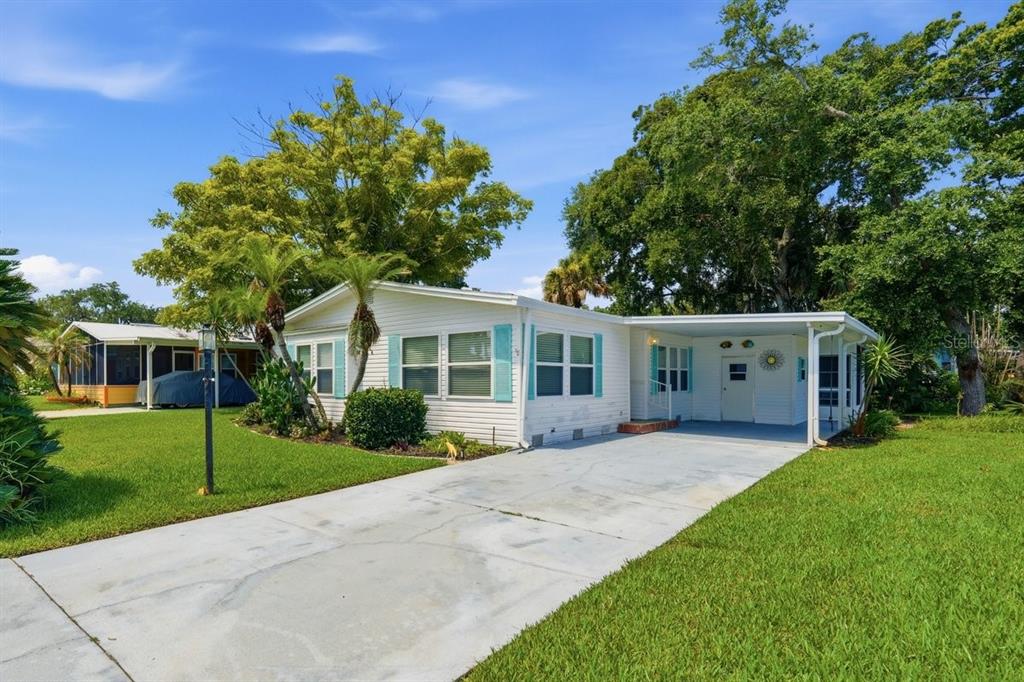 Front of Home showing Carport, Storage. Notice the long driveway