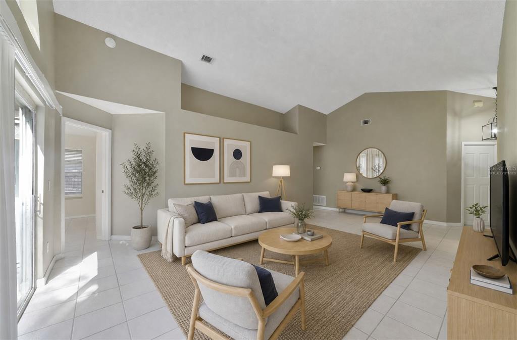 The spacious Living Room immediately catches your eye with its VAULTED CEILING, a unique decorative ledge and an ARCHED WINDOW positioned above the sliding glass doors that open to the back patio and SPACIOUS YARD, creating an easy connection between the indoor and outdoor spaces. Virtually Staged