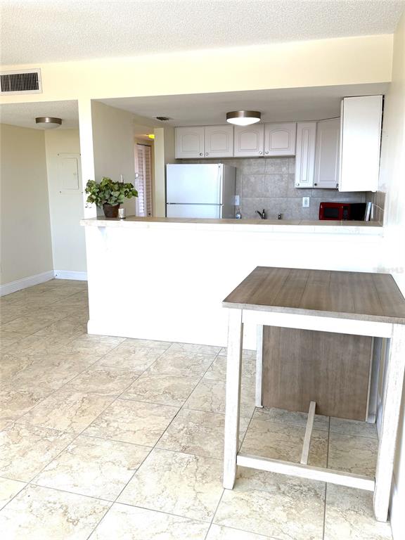 Open floor plan features a light & bright living room and kitchen in this cozy condo oasis.