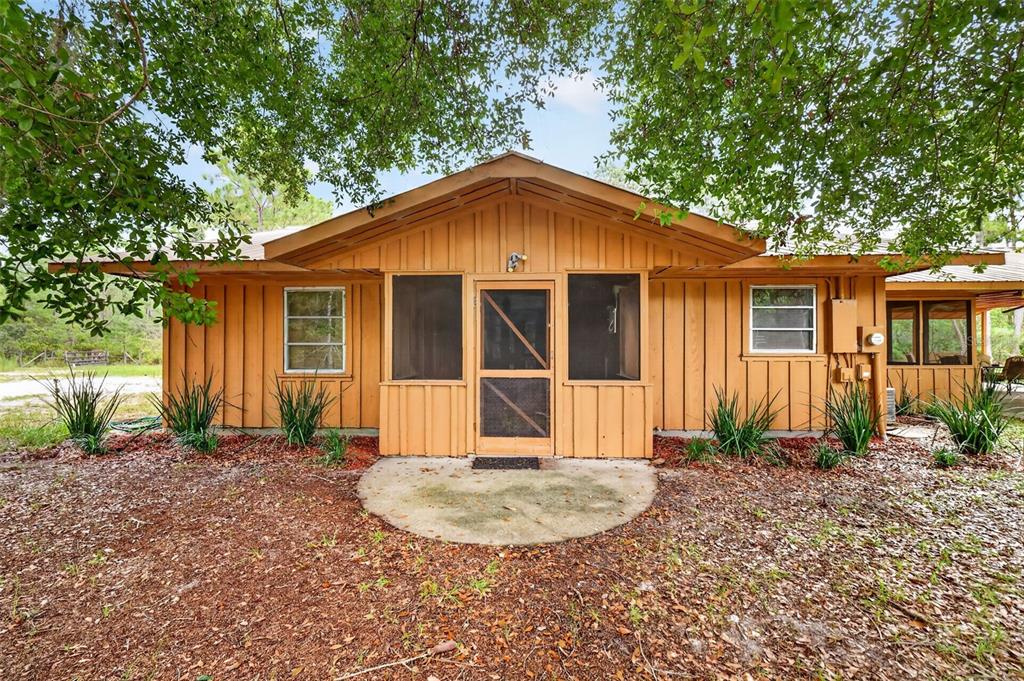 9" x 11' screened side porch with laundry hookups and tankless water heater access, cement landing entry
