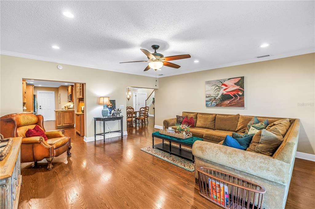 Spacious bonus family room (17x18) designed for effortless entertaining, featuring hurricane-rated sliders that offer seamless access to the screened porch and raised back patio.