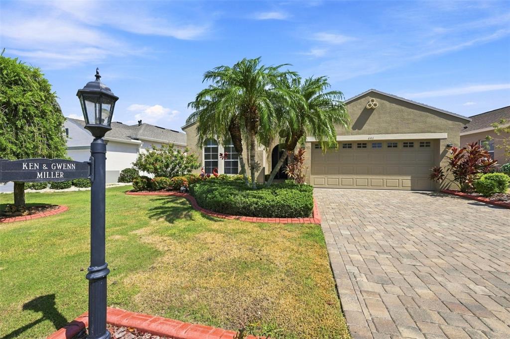 BEAUTIFULLY LANDSCAPED FRONT YARD WITH CONCRETE BOARDERS AND PAVER DRIVEWAY.