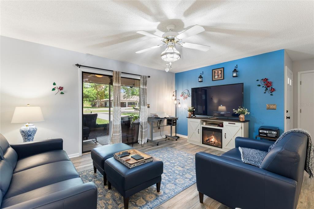 Living room is a gracious size and has direct access to the screened lanai area.