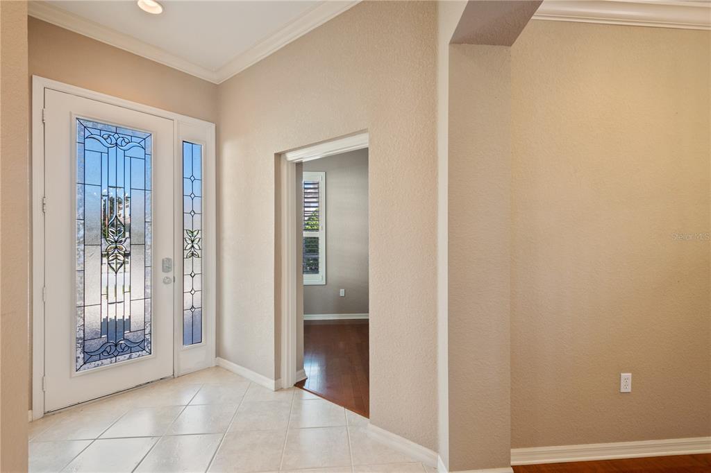 Step inside through the gorgeous lead glass entry door with sidelight panel . . .