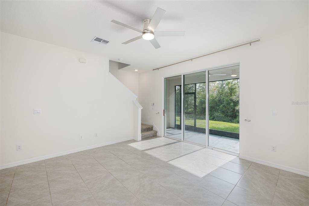 Living Room with Triple Sliders out to Lanai with Gorgeous View~