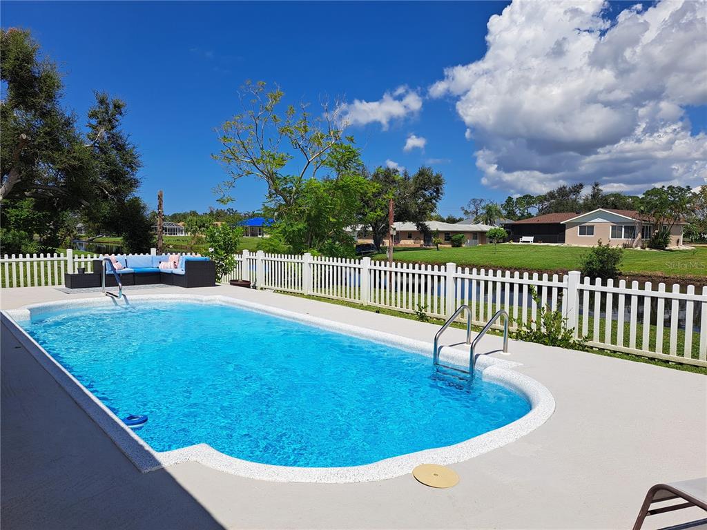 Enjoy the blue skies of this open air deck. Many opportunities for seating arrangements and entertaining options. The fenced in area allows for peace of mind with pets and children separating them from the freshwater canal.