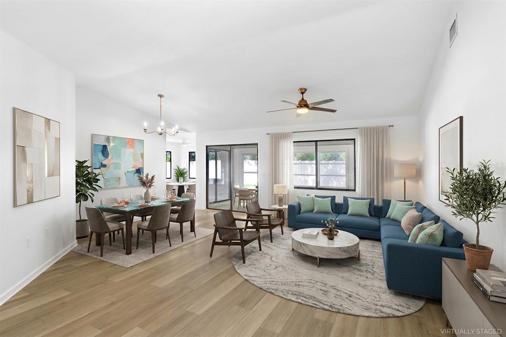 Virtually Staged: From Foyer to Living/Dining Room. Enclosed Patio and Outdoor terrace beyond the glass doors. Dinette and Kitchen to the left and two bedrooms with connected bathrooms to the right.