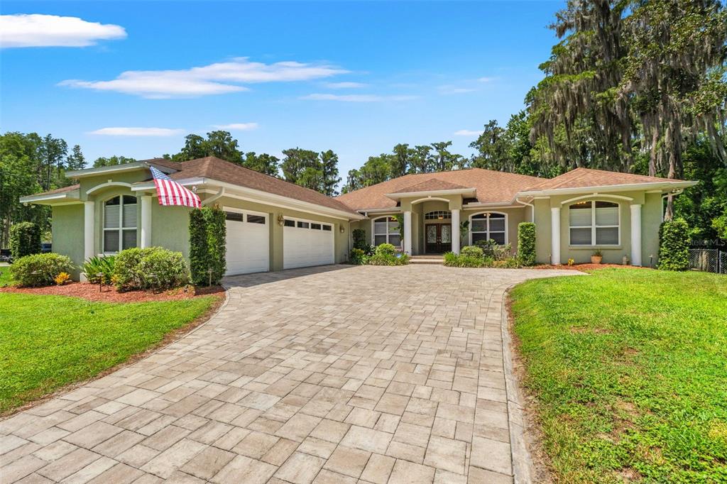 Private luxury estate on 5.21 acres in Land O’ Lakes — A welcoming circular-style driveway leads to this expansive 5-bedroom, 3-bath King Lake waterfront home with a 3-car garage, offering privacy, space, and an exceptional Florida lifestyle.