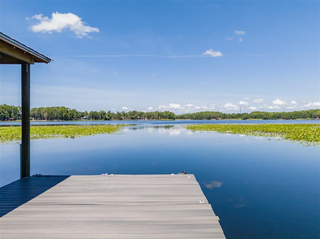 Private dock with boat lift on King Lake — Enjoy direct access to this beautiful 122-acre ski lake, perfect for boating, watersports, fishing, or simply relaxing on the dock and taking in the peaceful waterfront views.