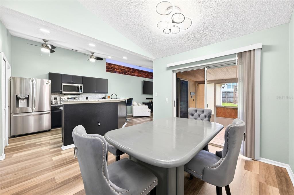 Dining room is open to the kitchen with its own set of sliding glass doors that open to the lanai.