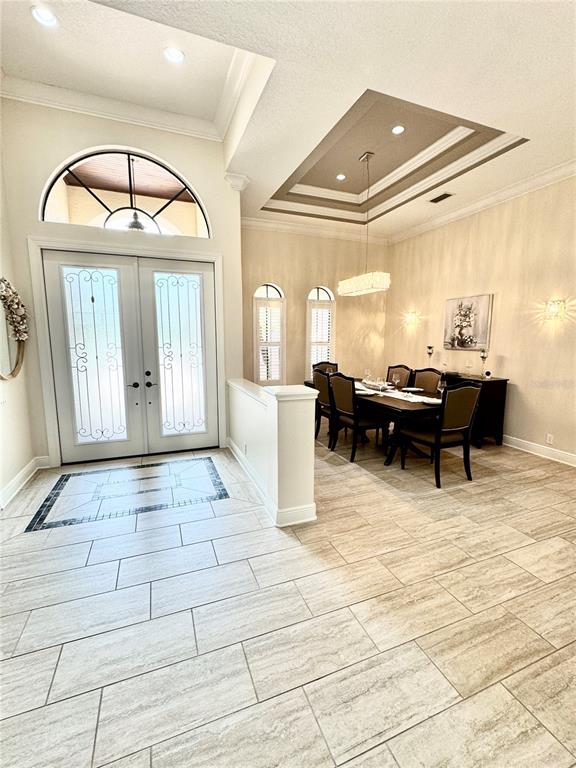 Foyer and dining area. Notice the tray ceiling and crown molding details.