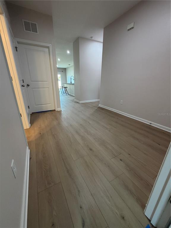 New Flooring in Large Kitchen features Oversized Granite Island Upgraded faucet and walk in pantry