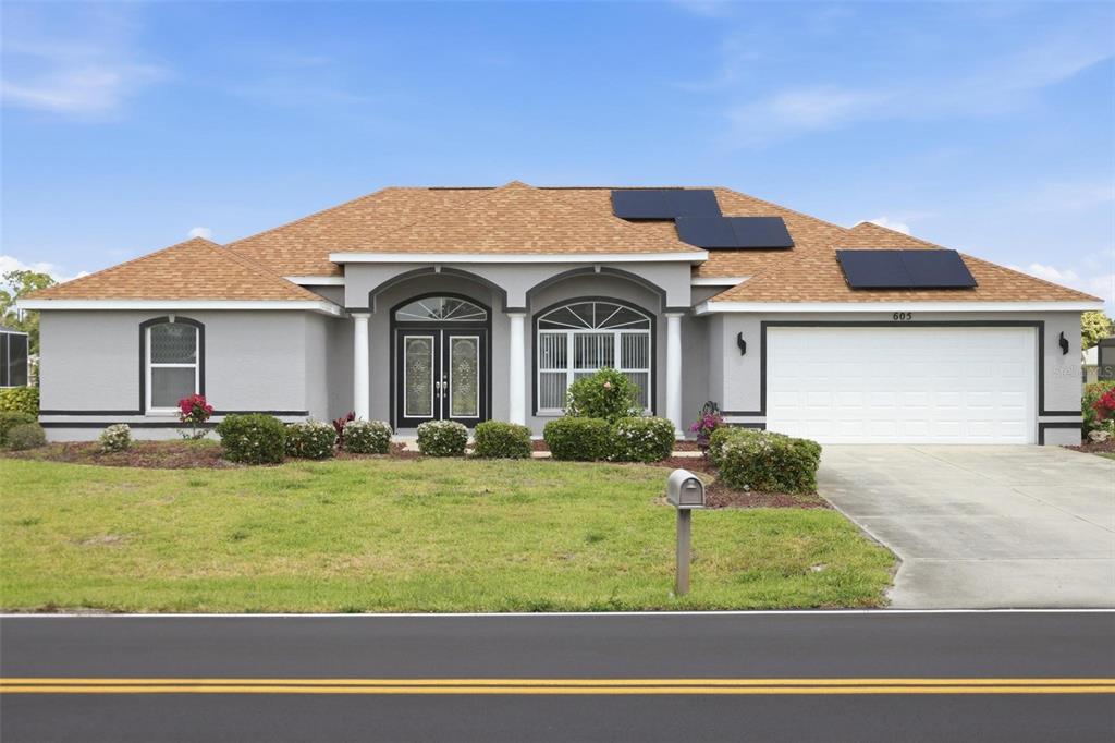 Freshly painted grey exterior on this move-in ready 3/2.5/2 single-family home