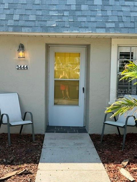 Bright yellow front door.  Screen door + plantation shutters