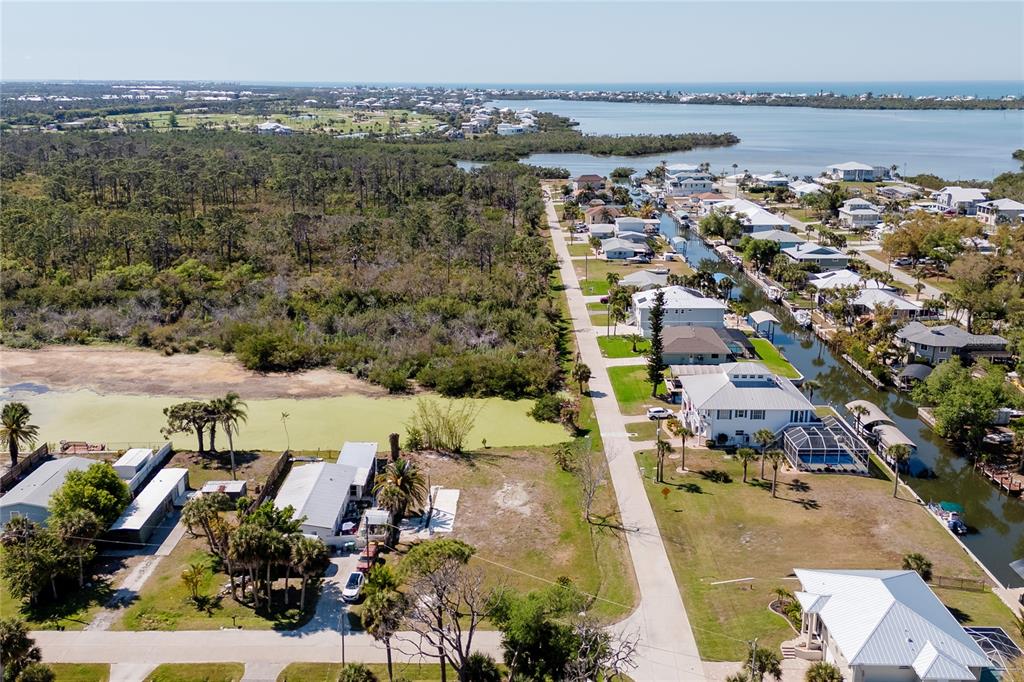 View from the east side, note the pone that this lot backs up to.   In the distance is the intercoastal and the Gulf of Mexiso.