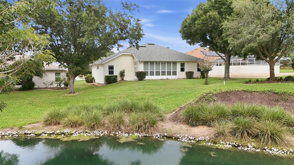 Peaceful water views complement the spacious backyard and enclosed lanai.