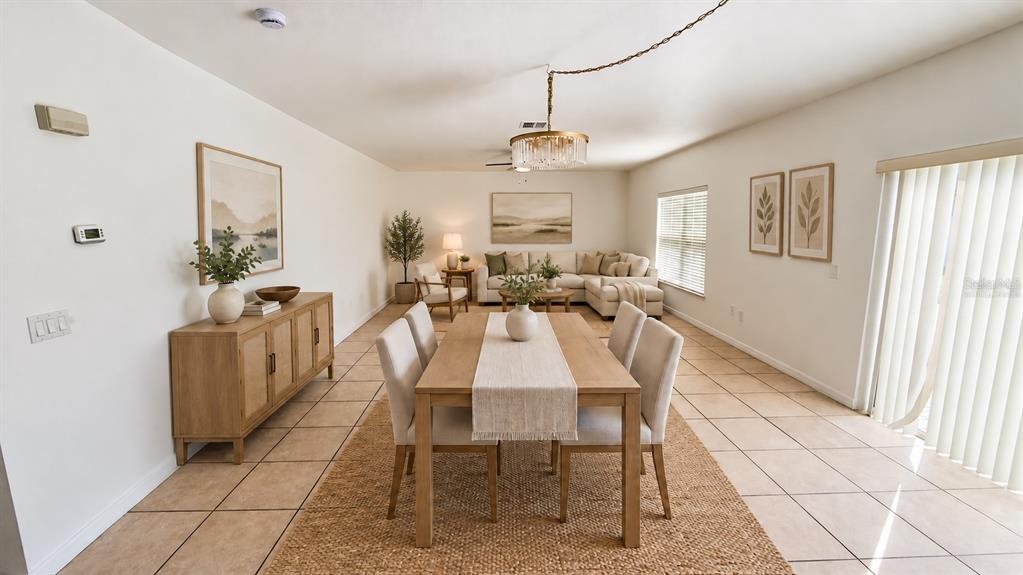 Virtually staged - Living and dining area. Digital furniture and decor illustrate a possible layout; furnishings are not included. Original unstaged view retained in this gallery.
