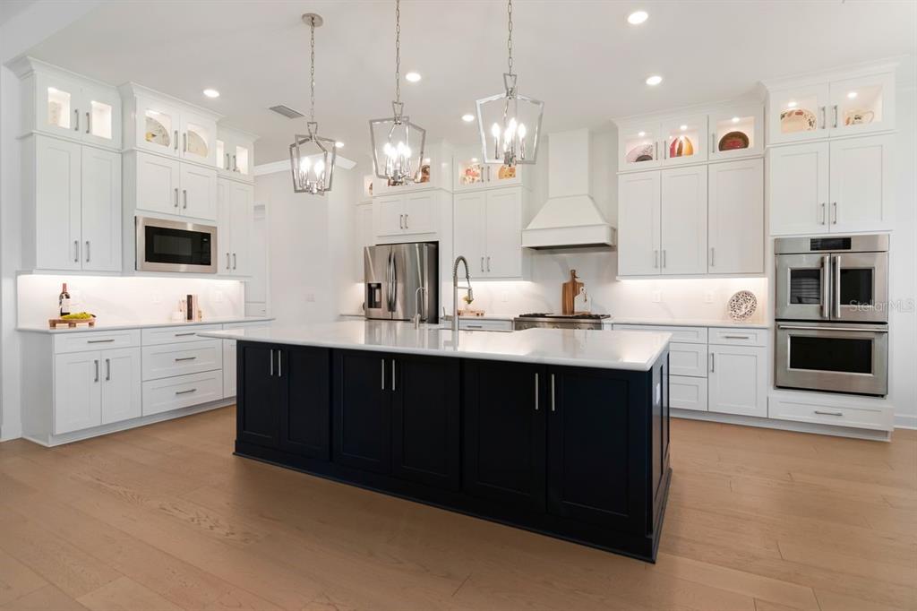 Chef's Kitchen - Quartz - Expansive Island with Storage - Pendant Lighting - Double Ovens - Gas Range & Hood - Butler's Pantry - Cabinets with Crown Molding