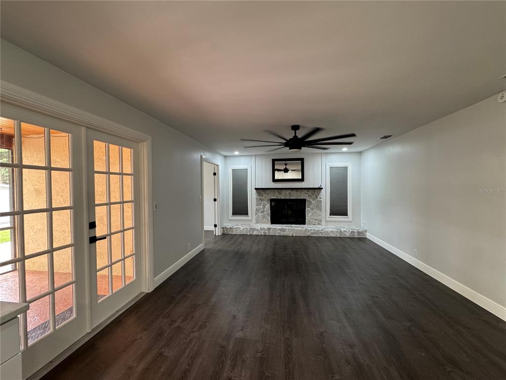 This image features a large, spacious family room designed for comfort and entertainment, offering an open floor plan that flows seamlessly into the rest of the home.