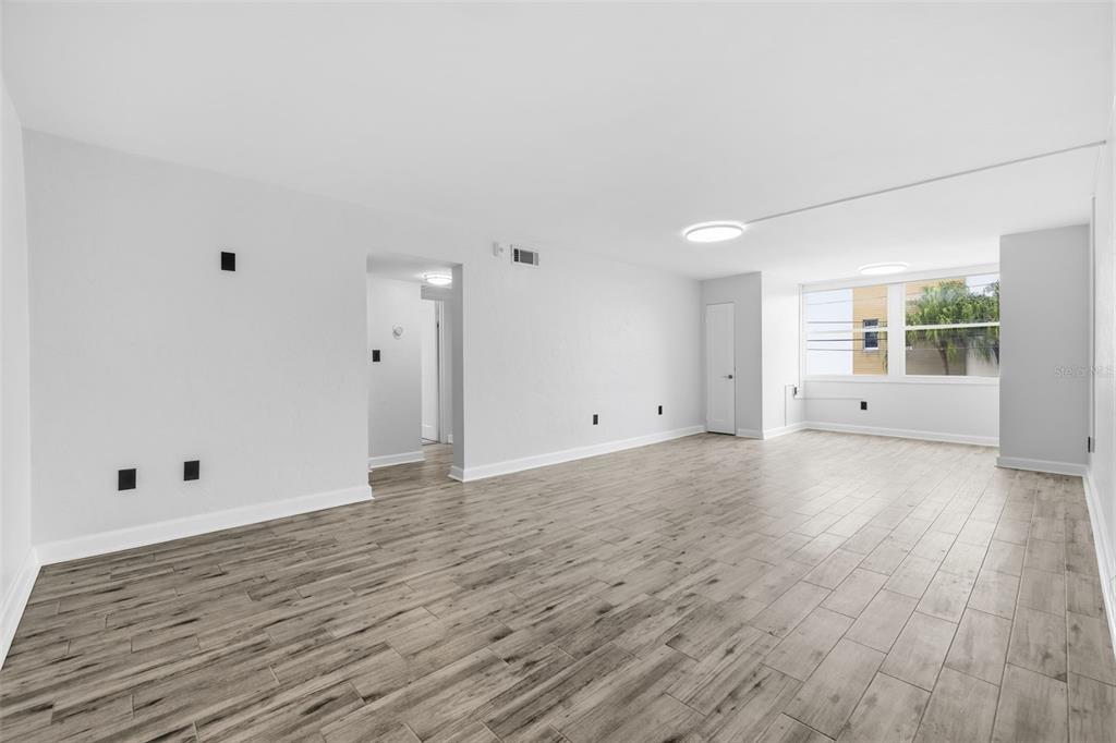 Step inside to a bright, freshly updated interior with new tile flooring and a spacious open living area.