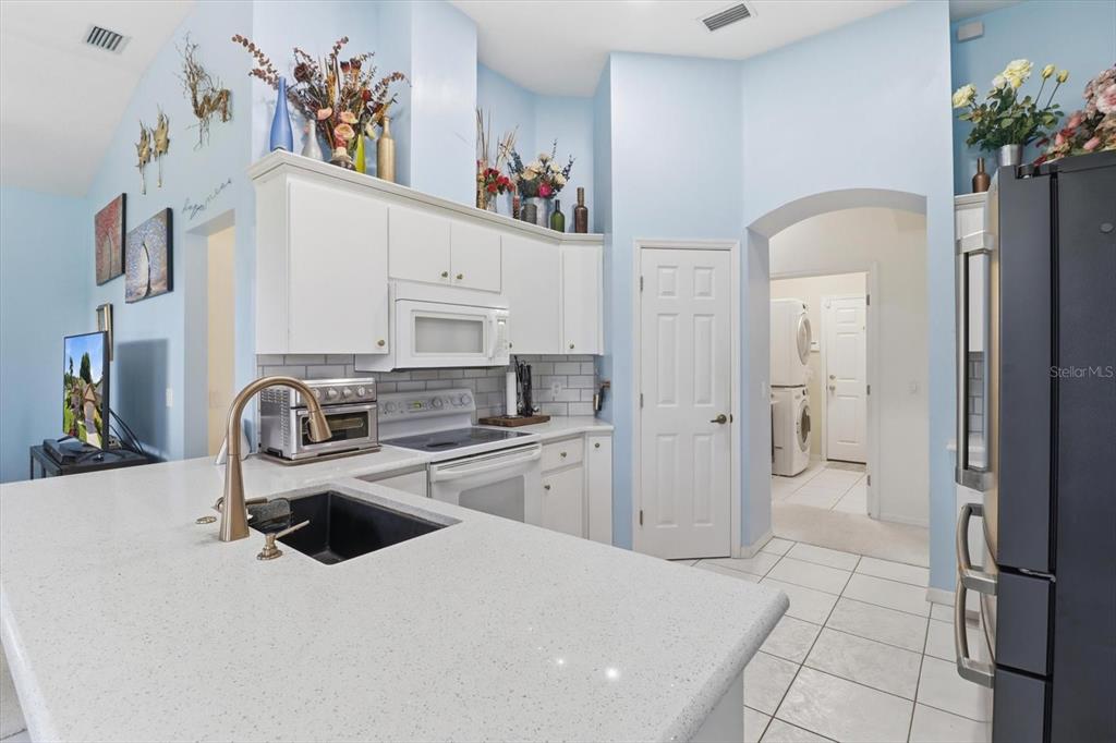 Freshly Painted Kitchen w/ Solid Surface Countertops, NEW White Subway Tile Backsplash, Breakfast Bar & Pantry Closet...FRIG DOES NOT CONVEY