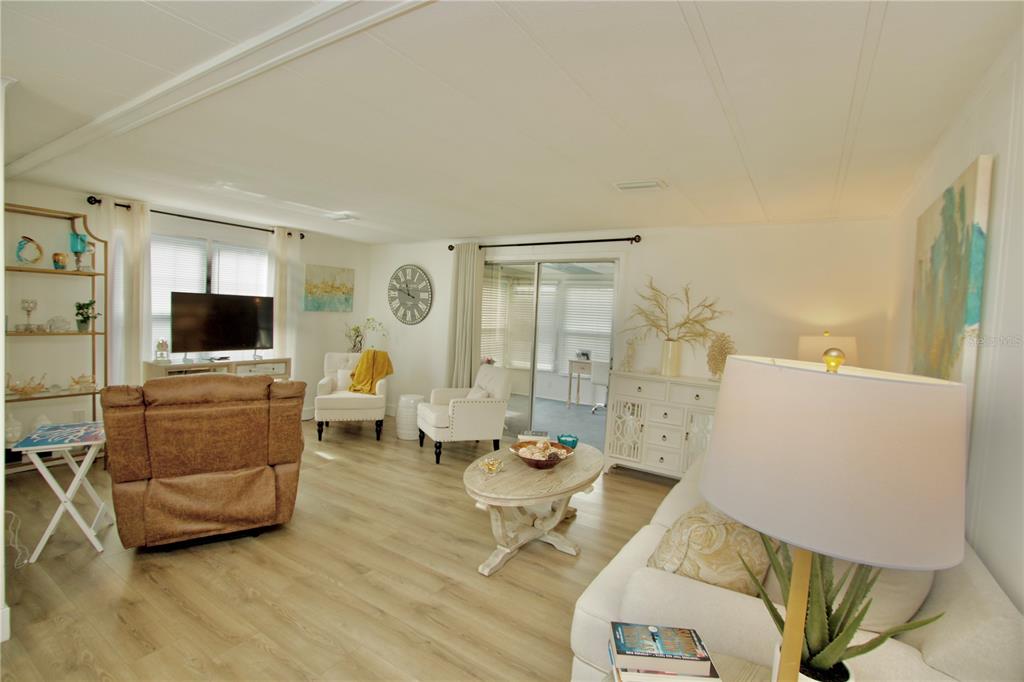 Living Room With Sliders Leading to Sunroom