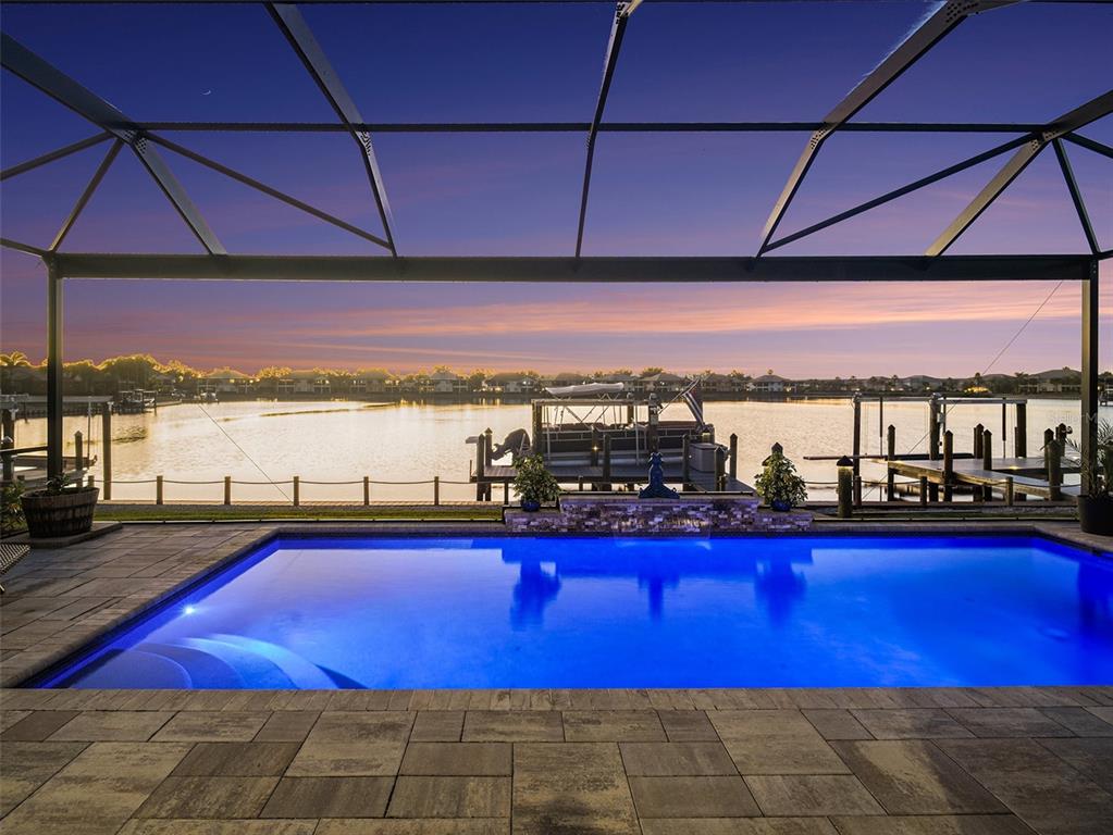 Evening pool and spa view with dramatic lighting, tranquil water, and a luxurious atmosphere for outdoor living.