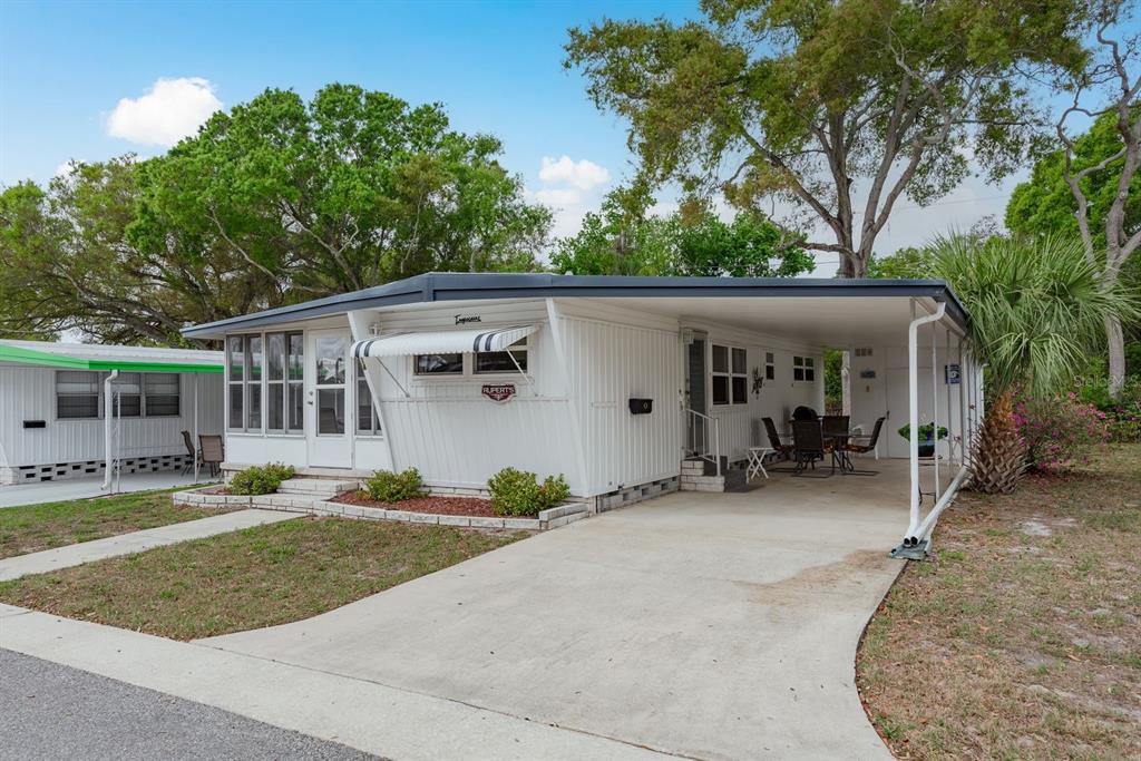 Front view with carport and storage shed!