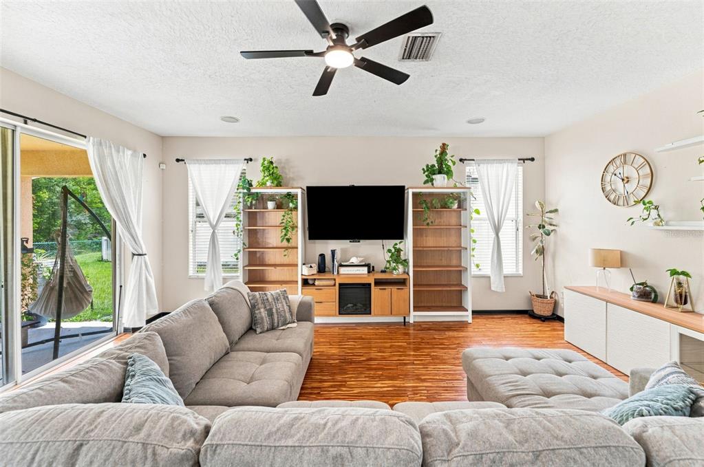 Spacious Family Room With Engineered Flooring and Surround Sound