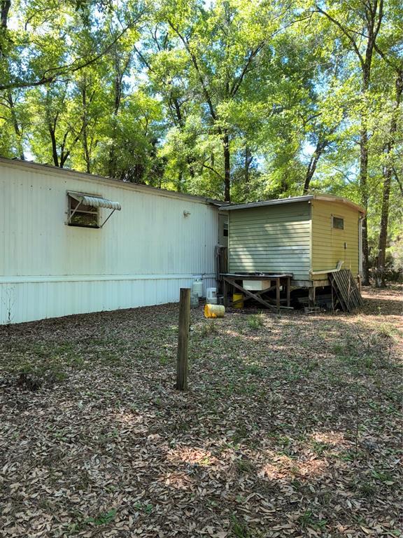 Rear or home. Shed just off of the back door houses the washer and dryer and a workbench. With some room for additional storage.