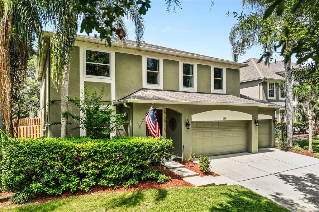 The front of home is framed by stately Palm.