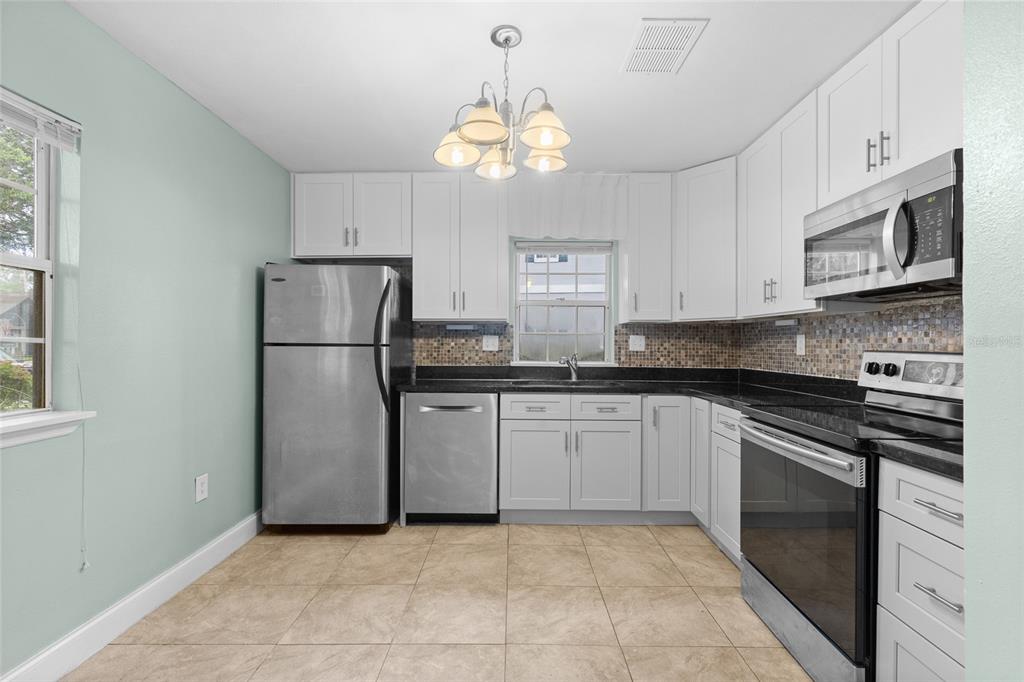 Kitchen with new cabinets, backsplash and countertops