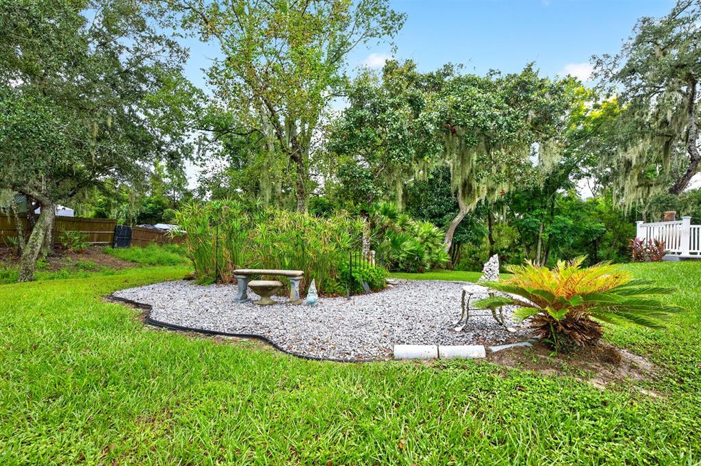 A small GARDEN AREA along the side yard has its own ELECTRICAL OUTLET, adding convenience for gardening projects or other outdoor uses.