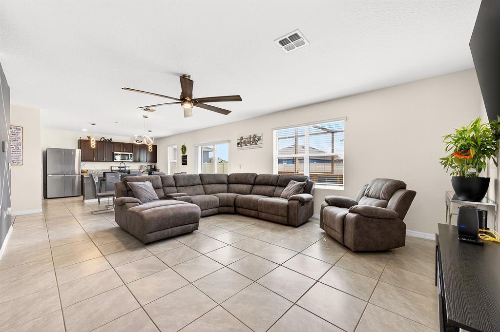 The interior offers a light, bright OPEN FLOOR PLAN designed for everyday living and entertaining – with TILE FLOORS that run throughout the main living areas, while large windows and sliding glass doors bring in natural light and provide easy access to the backyard and patio!