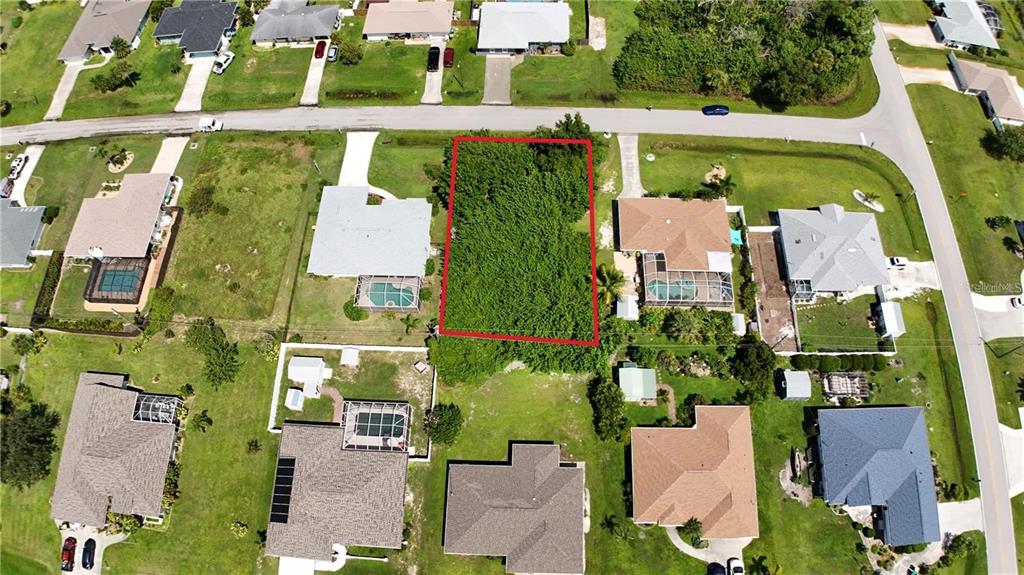 Aerial view of lot surrounded by appealing neighborhood.