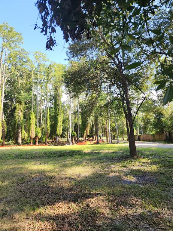 View from the rear property line looking 264 feet toward the street and cul-de-sac, showcasing the depth of the lot and prepared building site. Upland area is 0.4 Acre.