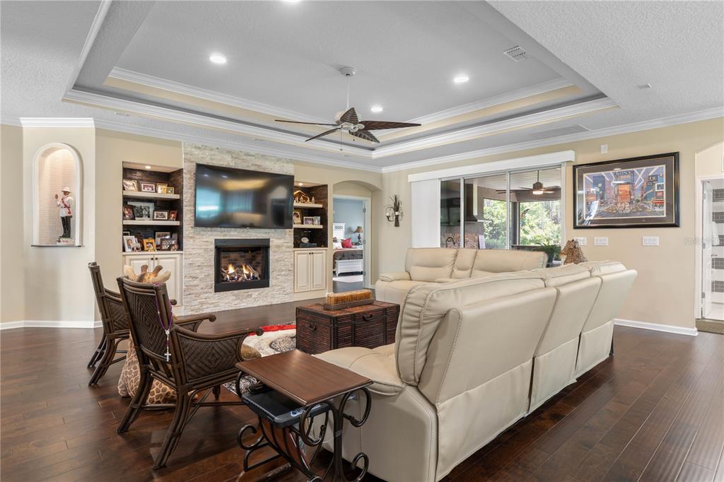 Where cozy meets character—hand-scraped wood floors set the stage for everyday living, while the gas fireplace creates the perfect spot to gather, unwind, and feel right at home.
