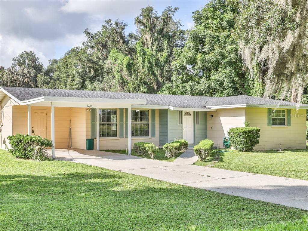 Front of the home with a one car carport.