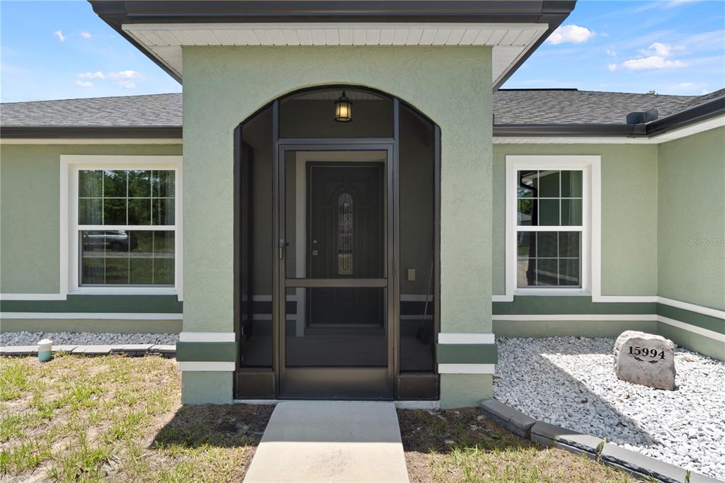 A welcoming screened front porch sets the tone before you even step inside.