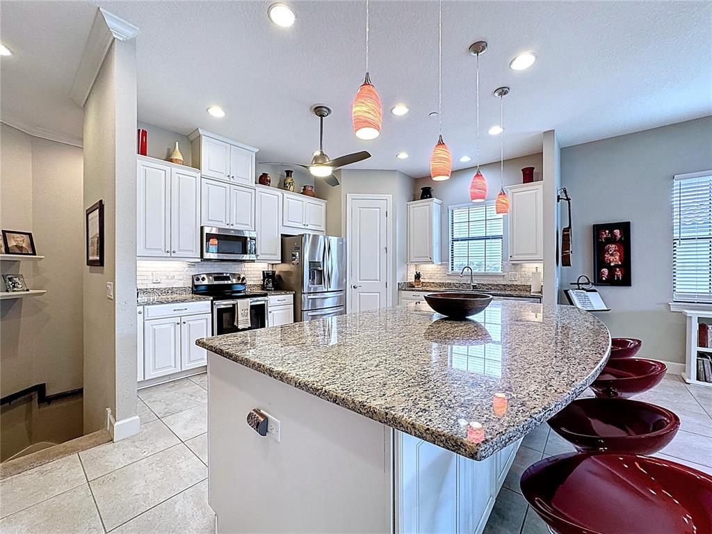 Kitchen w/ White Cabinetry & Ex Large Counter