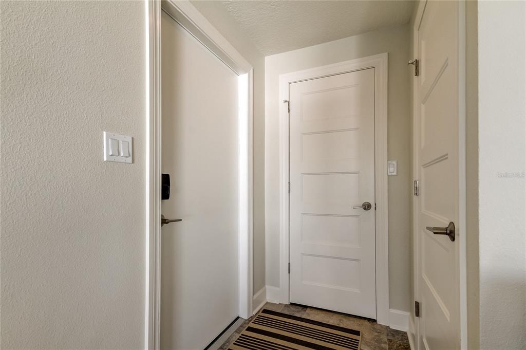 Front door on the left, Two closets for storage and entrance to the attic.
