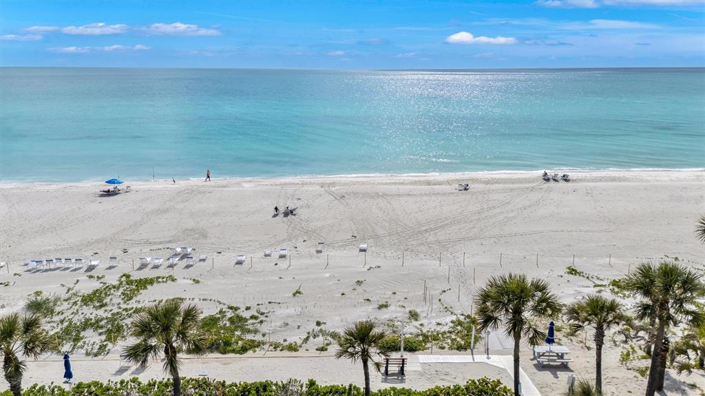 Actual photo of the Beach Harbor Club’s exclusive beach facility with Tiki huts and bar-b-que. plenty of chaise lounge seating. Also has a fresh water shower beachside