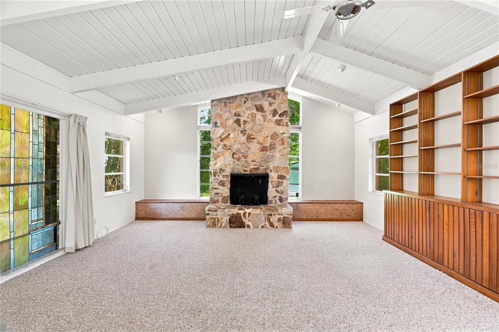 Family Room - vaulted ceiling, wood burning fireplace, vintage stained glass window