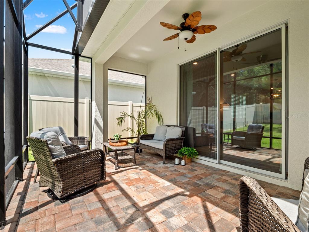 Covered and screened extended brick paved lanai.